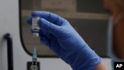 FILE - A vial of the Phase 3 Novavax coronavirus vaccine is seen ready for use in the trial at St. George's University hospital in London, Oct. 7, 2020. 