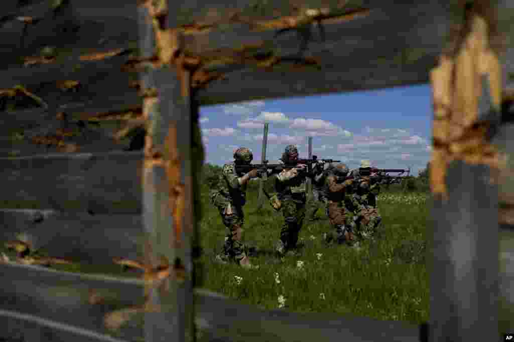 Civilian militia men aim their rifles&nbsp; during training at a shooting range on the outskirts of Kyiv, Ukraine.