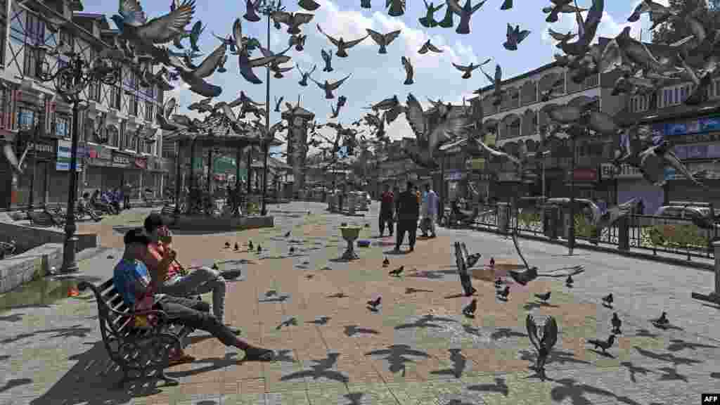 People sit on a bench during a protest against former India's Bharatiya Janata Party spokeswoman Nupur Sharma over her remarks about Prophet Mohammed, in Srinagar.