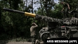 Ukrainian troop members repair an army's Main Battle Tank (MBT) in the eastern Ukrainian region of Donbas on June 7, 2022