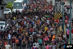 Latin American migrants take part in a caravan towards the border with the United States, in Huehuetan, Chiapas state, Mexico, on June 7, 2022.