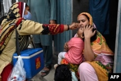 파키스탄 보건 종사자가 지난달 23일 라호르 지역 어린이에게 소아마비 백신을 투여하고 있다.