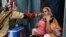 A health worker administers polio vaccine drops to a child during a door-to-door polio vaccination campaign at a slum area in Lahore, Pakistan, May 23, 2022. 