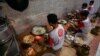 Employees fry sliced tempe, a traditional Indonesian food made from fermented soybeans, at a home industry that produces chips in Jakarta May 18, 2022