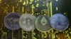 ARCHIVO - Representaciones de las monedas virtuales Ripple, Bitcoin, Ethereum y Litecoin se ven en una placa base de PC en esta imagen ilustrativa. 