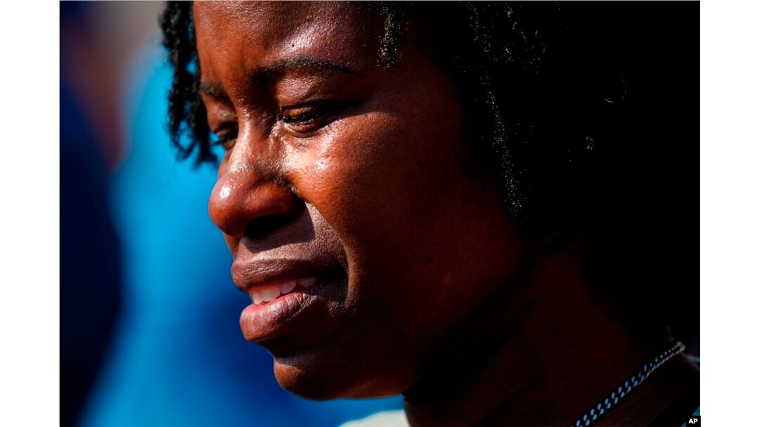 File - A person is overcome with emotions outside the scene of a shooting at a supermarket, in Buffalo, N.Y., May 15, 2022, one of several shootings in the U.S.. in recent weeks.