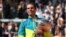 Spain's Rafael Nadal poses with The Musketeers' Cup as he celebrates after victory over Norway's Casper Ruud during their men's singles final match on day fifteen of the Roland-Garros Open, June 5, 2022.