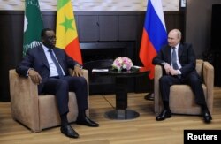 Russia's President Vladimir Putin (right) attends a meeting with Senegal's President Macky Sall, currently the chairman of the African Union, at the Bocharov Ruchei state residence in Sochi, Russia, June 3, 2022, in a Sputnik/Mikhail Klimentyev/Kremlin.