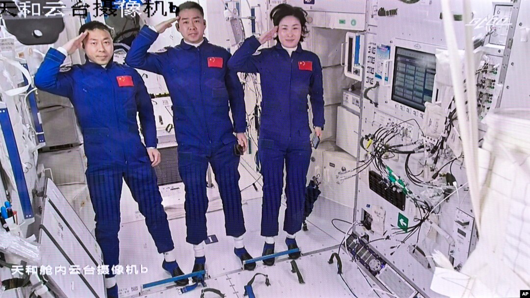 FILE: In this screenshot captured at Beijing Aerospace Control Center and released by Xinhua News Agency, Chinese astronauts from left, Liu Yang, Chen Dong and Cai Xuzhe salute after entering the space station core module Tianhe, June 5, 2022.