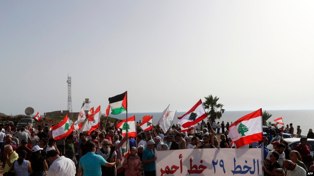 Lebanese protesters in Naqoura, Lebanon demonstrate after Israel moved a gas production vessel into an offshore field, a part of which is claimed by Lebanon, June 11, 2022.