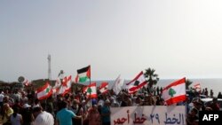 Lebanese protesters in Naqoura, Lebanon demonstrate after Israel moved a gas production vessel into an offshore field, a part of which is claimed by Lebanon, June 11, 2022.