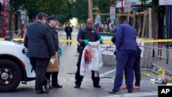 Philadelphia Police investigators work the scene of a fatal overnight shooting on South Street in Philadelphia, Pennsylvania, June 5, 2022.