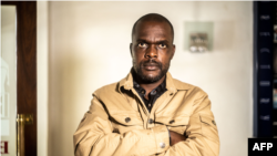 FILE - A portrait of Freelance journalist for the New York Times, Jeffery Moyo poses for a photograph after his release from detention at the Bulawayo prison in Bulawayo on June 16, 2021. (Photo by Zinyange Auntony / AFP)