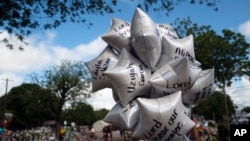 Balloons honoring the victims killed in the May 24 school shooting sway in the wind at a memorial at Robb Elementary School in Uvalde, Texas, June 2, 2022.