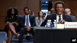 Garnell Whitfield Jr., of Buffalo, New York, whose mother, Ruth Whitfield, was killed in the Buffalo supermarket mass shooting, testifies at a Senate Judiciary Committee hearing on domestic terrorism, June 7, 2022, in front of other family members on Capitol Hill in Washington.
