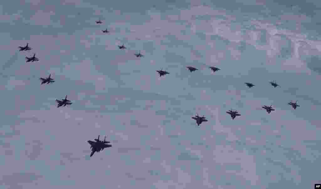 In this photo provided by South Korea Defense Ministry, U.S. and South Korean fighter jets fly in formation over South Korea&#39;s western sea during a joint drill.