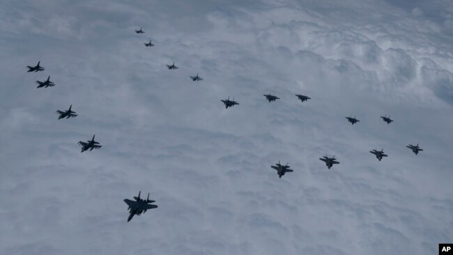 In this photo provided by South Korea Defense Ministry, US and South Korean fighter jets fly in formation during a joint drill, June 7, 2022. (South Korean Defense Ministry via AP)