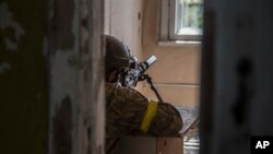 A Ukrainian soldier is in position during heavy fighting on the front line in Severodonetsk, the Luhansk region, Ukraine, June 8, 2022.