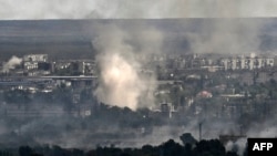 Smoke rises from shelling in the city of Sievierodonetsk during fighting between Ukrainian and Russian troops in the eastern Ukrainian region of Luhansk, June 7, 2022.