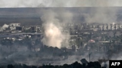 Smoke rises from shelling in the city of Sievierodonetsk during fighting between Ukrainian and Russian troops in the eastern Ukrainian region of Luhansk, June 7, 2022.