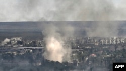 Smoke rises from shelling in the city of Sievierodonetsk during fighting between Ukrainian and Russian troops in the eastern Ukrainian region of Luhansk, June 7, 2022.