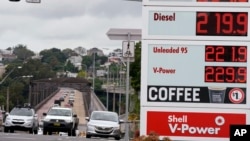 FILE - Motorists drive past a fuel price display in Sydney, March 29, 2022. With inflation increasing in Australia the government is expected to reduce its 44.2 Australian cents (33.1 U.S. cents) a liter ($1.25 a gallon) tax on gasoline. 