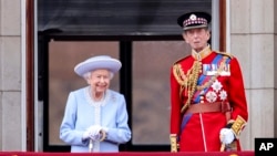 Queen Elizabeth II and the Duke of Kent watch from the balcony of Buckingham Place after the Trooping the Color ceremony in London, June 2, 2022, on the first of four days of celebrations to mark the Platinum Jubilee.