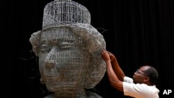 Artist Carl Gabriel works in his studio on a sculpture made of wire depicting the head of Britain's Queen Elizabeth II, made for the Platinum Jubilee Pageant, in London, June 1, 2022.