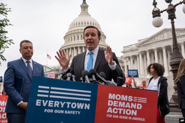 FILE - Democratic Senator Chris Murphy is joined at left by Sen. Alex Padilla, also a Democrat, as they speak to activists demanding action on gun control legislation, at the Capitol, in Washington, May 26, 2022. (AP Photo/J. Scott Applewhite)