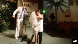 FILE - Brian Mills, as Elvis marries Richard Johnson and Cheryl Bell of Peoria, Ariz. at the Viva Las Vegas wedding chapel, Sept. 9, 2009 in Las Vegas. 