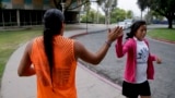 Native American students high fiving as they pass each other at the University of California, Riverside, June 26, 2014. 