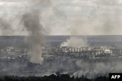 Smoke and dirt rise from shelling in the city of Sievierodonetsk during fight between Ukrainian and Russian troops in the eastern Ukrainian region of Donbas on June 7, 2022. (Photo by Aris Messinis / AFP)