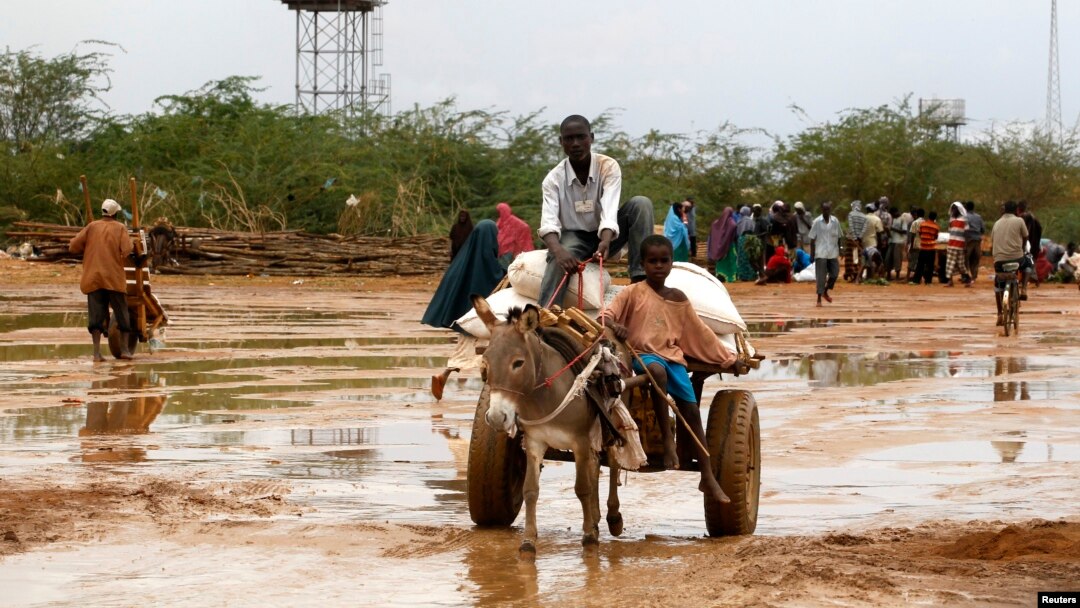 FILE - Newly arrived Somali refugees ride a donkey along the street at the Ifo Extension refugee camp in Dadaab, near the Kenya-Somalia border, Oct. 19, 2011.