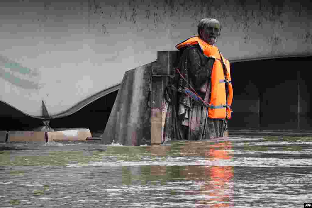 The Zouave statue of the Pont D&#39;Alma bridge standing partially submerged after the River Seine burst its banks in Paris, France, wears a life jacket put by activists of the Fondation Goodplanet.