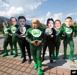 Protestors wearing masks of G-7 leaders during a demonstration one day before the G-7 summit, in Garmisch-Partenkirchen, southern Germany, June 6, 2015. The summit is to take place June 7-8 at Schloss Elmau hotel near Garmisch-Partenkirchen.
