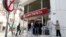 Depositors wait to enter a branch of Laiki Bank in Nicosia, Cyprus, March 29, 2013. 