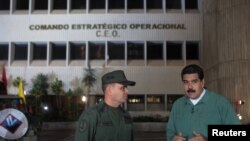 FILE - Venezuela's President Nicolas Maduro (R) speaks with Venezuela's Defense Minister Vladimir Padrino Lopez, during his weekly broadcast "En contacto con Maduro" (In contact with Maduro) in Caracas, Venezuela July 12, 2016.