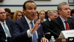 United Airlines CEO Oscar Munoz, left, accompanied by United Airlines President Scott Kirby, appears on Capitol Hill in Washington, May 2, 2017, to testify before a House Transportation and Infrastructure Committee oversight hearing. 