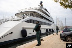 FILE - Civil Guards stand by the yacht called Tango in Palma de Mallorca, Spain, April 4, 2022. The yacht is among the assets linked to Viktor Vekselberg, a Russian oligarch.