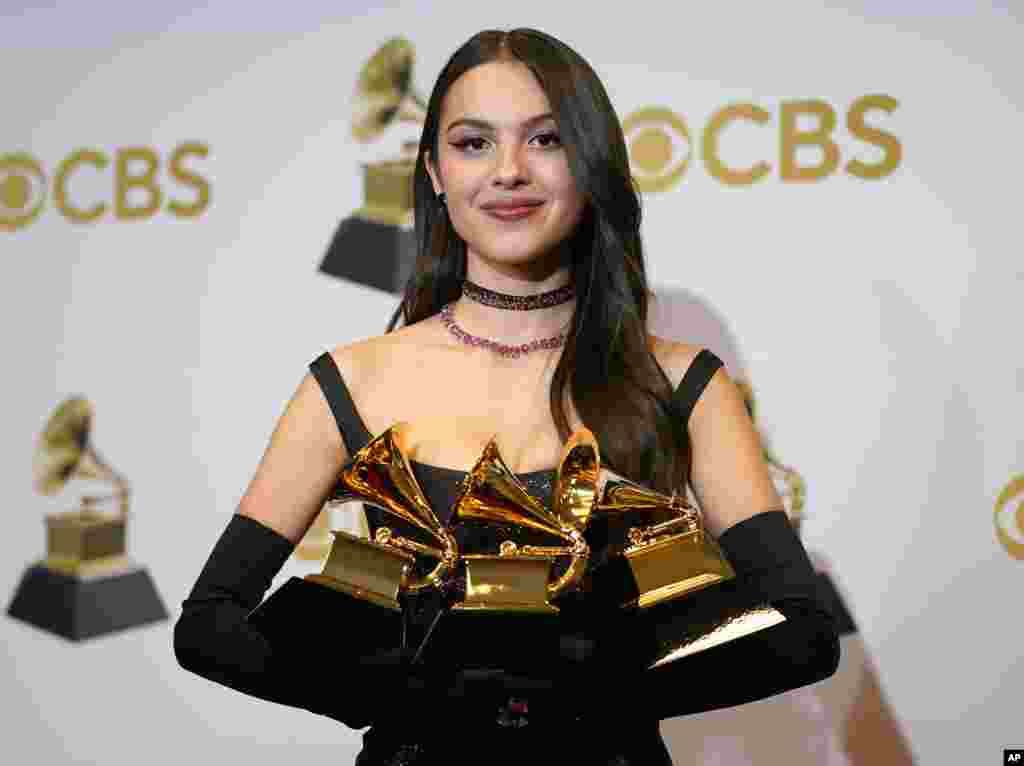 Olivia Rodrigo, winner of the awards for best pop vocal album for &quot;Sour,&quot; best new artist and best pop solo performance for &quot;Drivers License,&quot; poses in the press room at the 64th Annual Grammy Awards at the MGM Grand Garden Arena, April 3, 2022, in Las Vegas.