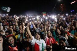 Supporters of the Pakistan Tehreek-e-Insaf (PTI) political party light up their mobile phones and chant slogans in support of Pakistani Prime Minister Imran Khan during a rally, in Islamabad, Pakistan April 4, 2022.
