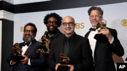 Joseph Patel, from left, Questlove, David Dinerstein and Robert Fyvolent, winners of the award for best music film for "Summer of Soul," pose in the press room at the 64th Annual Grammy Awards at the MGM Grand Garden Arena on Sunday, April 3, 2022, in Las