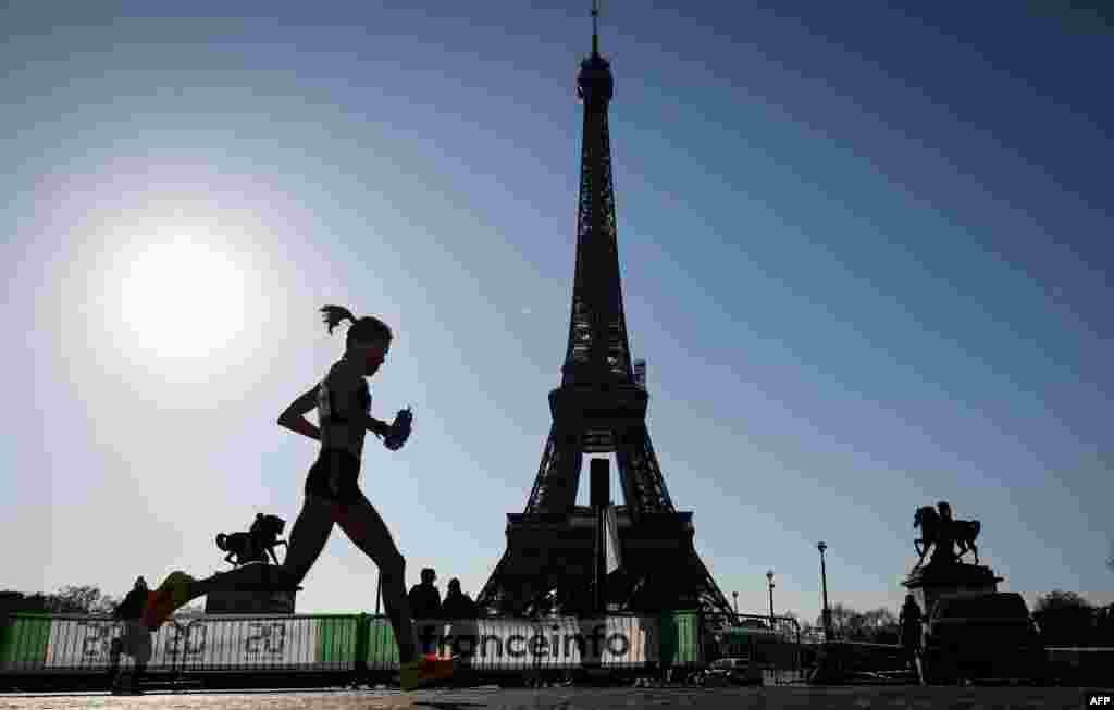 Runners compete in front of the Eiffel Tower during the 46th edition of the Paris Marathon in Paris, France.