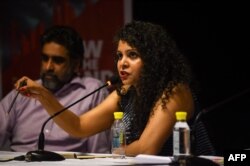 FILE - Indian journalist and author Rana Ayyub speaks during the launch of her self-published book 'Gujarat Files' in New Delhi, May 27, 2016.
