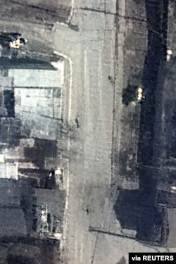 A satellite image shows dead bodies on Yablonska Street in Bucha, Ukraine, March 19, 2022. Satellite image 2022 Maxar Technologies.