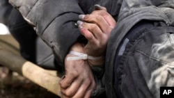 A dead civilian with his hands tied behind his back lies on the ground in Bucha close to Kyiv, Ukraine, April 4, 2022.