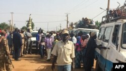 FILE: Malians gather on July 29, 2019 in Koro, close to the border with Burkina Faso, in central Mali. People took refuge in the city of Koro following a wave of mass killings this year, including the massacre of 41 people.