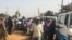 FILE: Malians gather on July 29, 2019 in Koro, close to the border with Burkina Faso, in central Mali. People took refuge in the city of Koro following a wave of mass killings this year, including the massacre of 41 people.