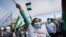 Supporters of National Liberation Party presidential candidate Jose Maria Figueres wave flags outside of a polling station during a runoff presidential election, in San Jose, Costa Rica, April 3, 2022.