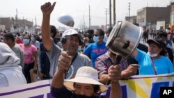 Drivers and residents protest on the Autopista Central, where buses and trucks were parked to block the road, in Huaycan, on the outskirts of Lima, Peru, on Monday, April 4, 2022. 